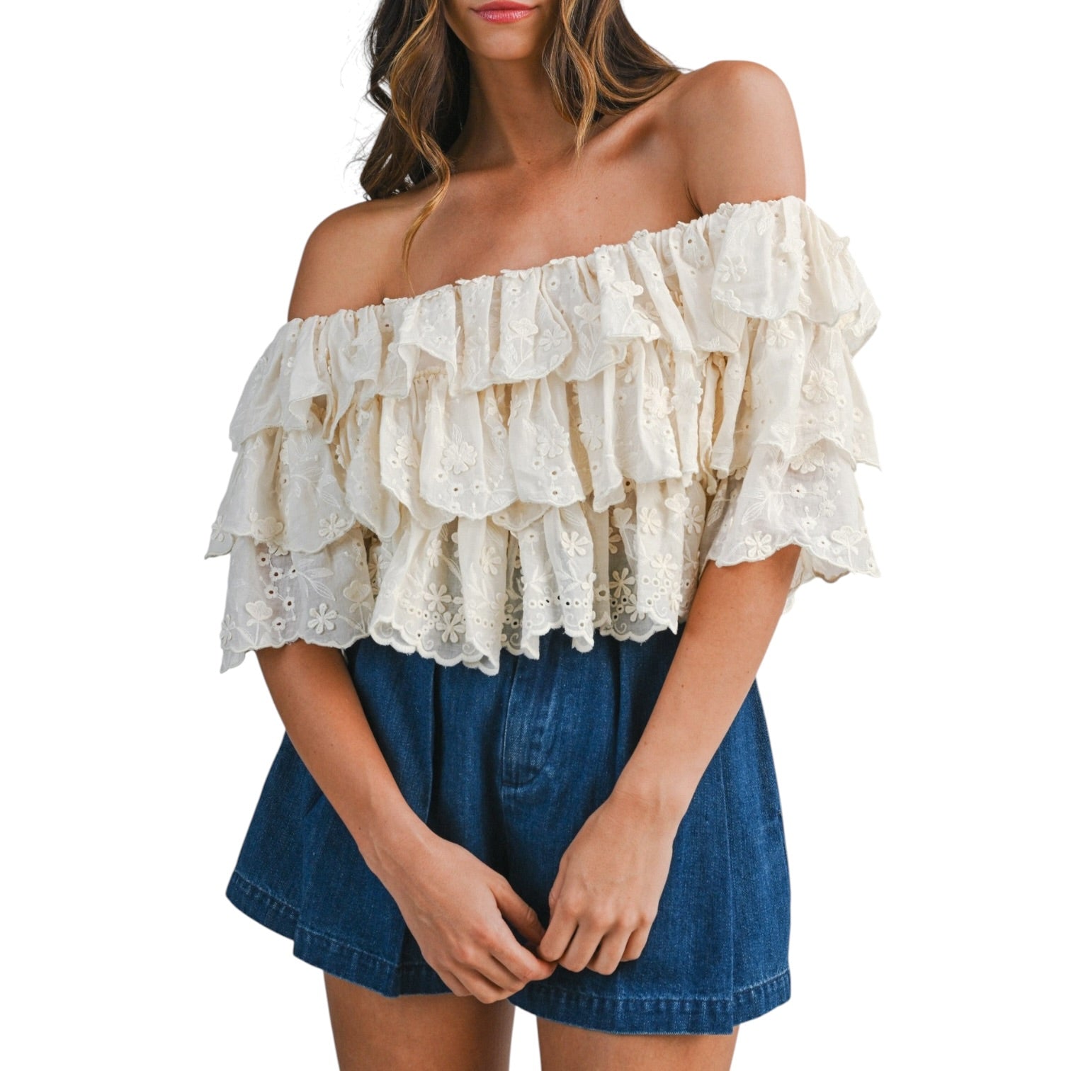 woman wearing tiered off shoulder lace top with pleated denim shorts