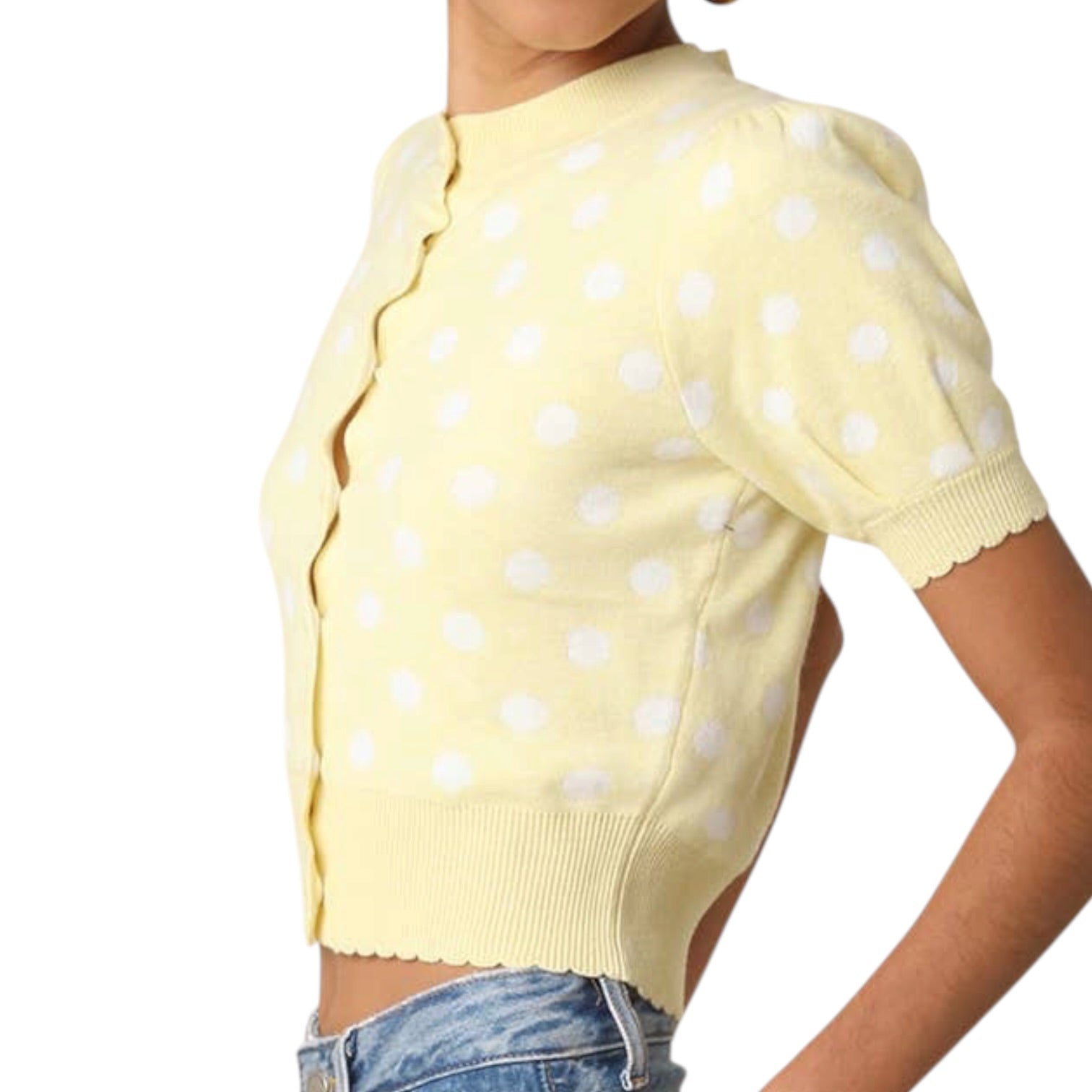 Yellow polka dot sweater worn by a person on a white background