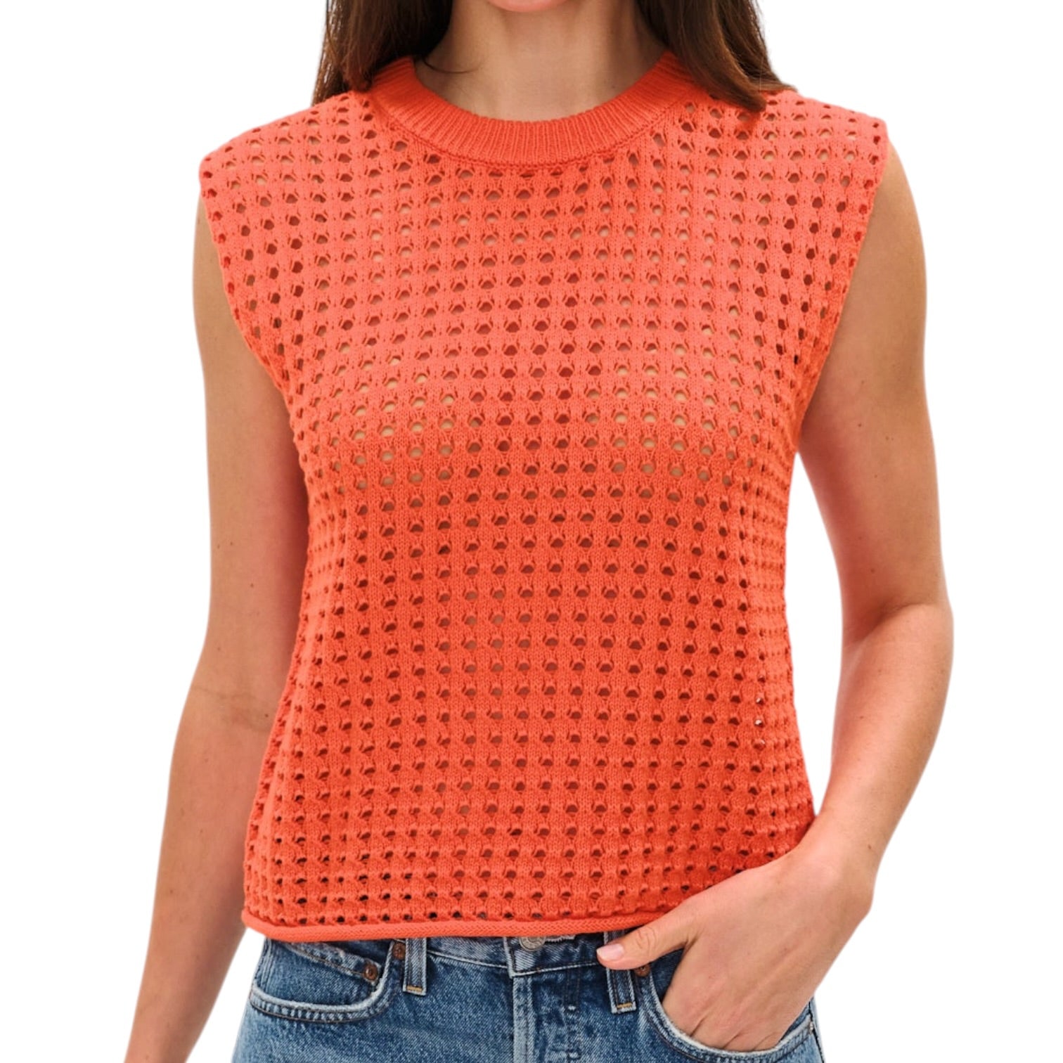 Person wearing an orange sleeveless knitted top on a white background