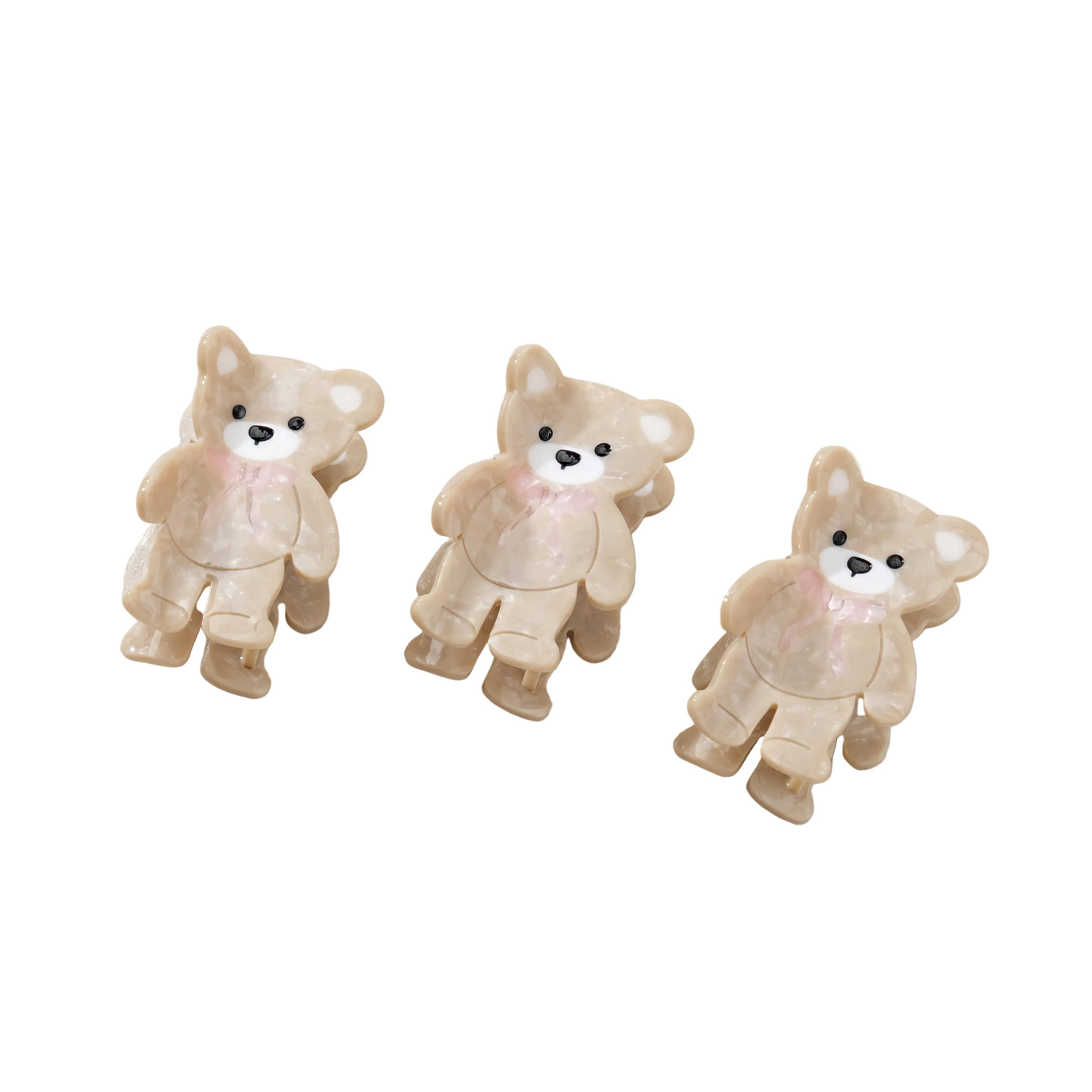 Three teddy bear-shaped hair clips on a white background