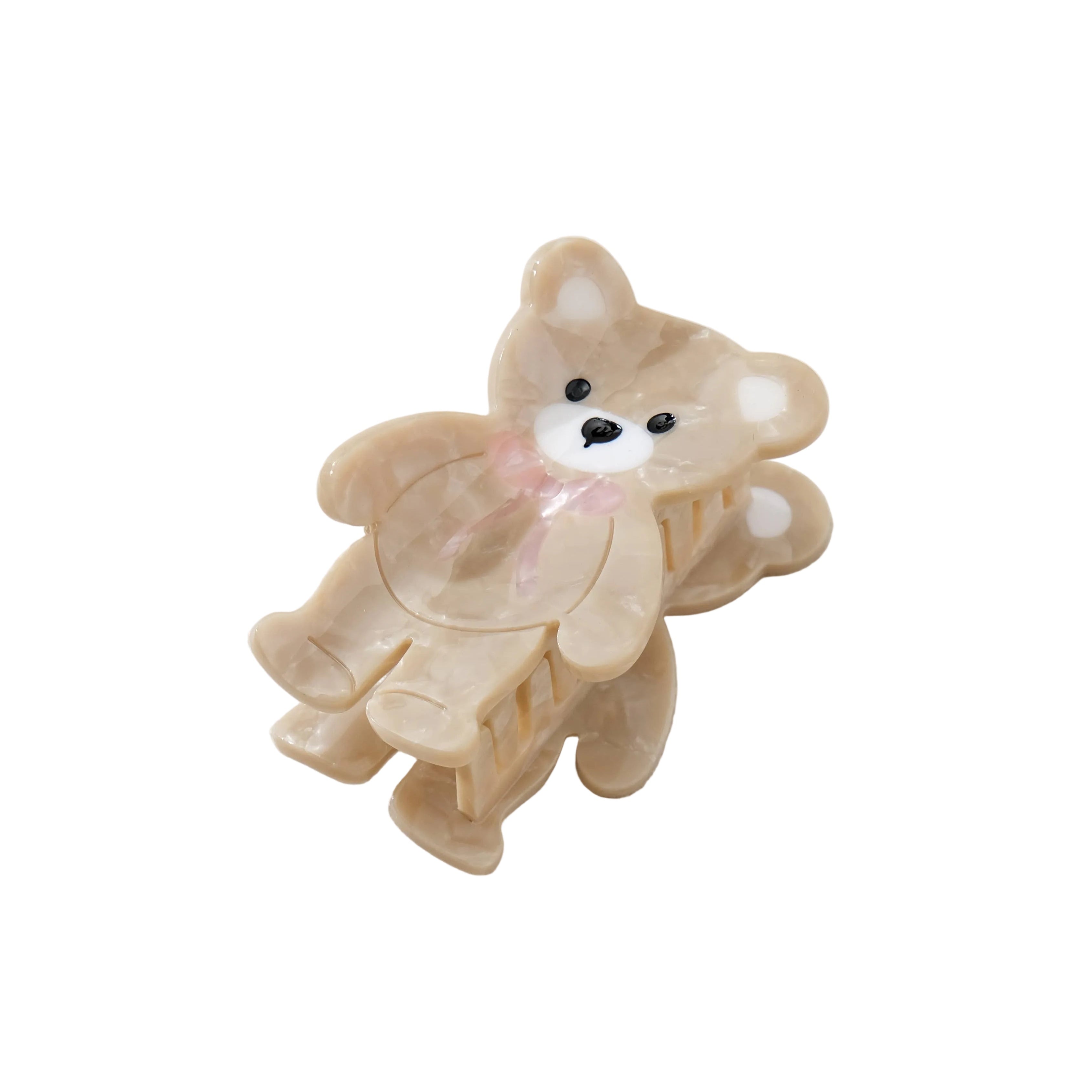 Beige teddy bear-shaped hair clip on a light gray background