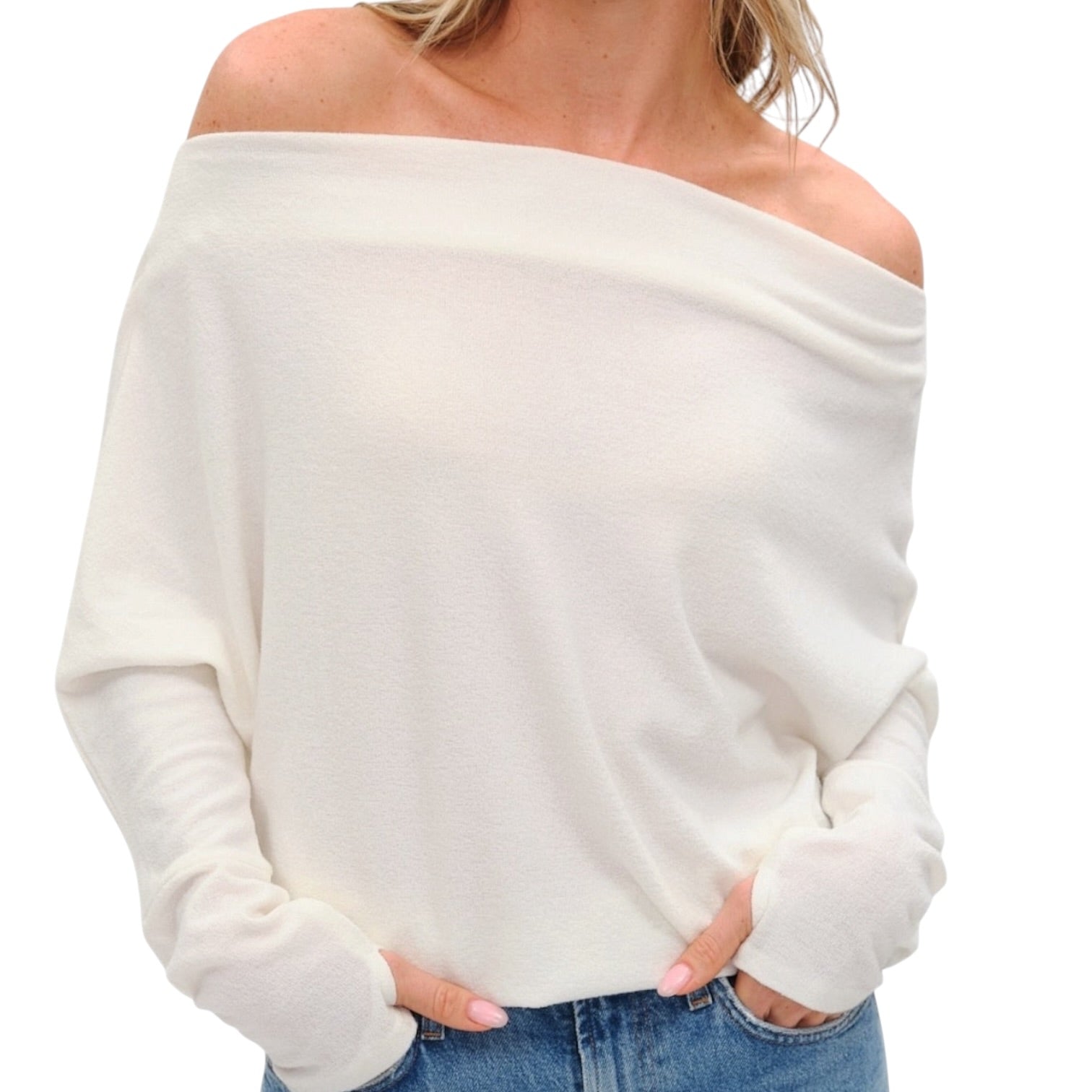 White off-shoulder sweater worn by a person on a white background