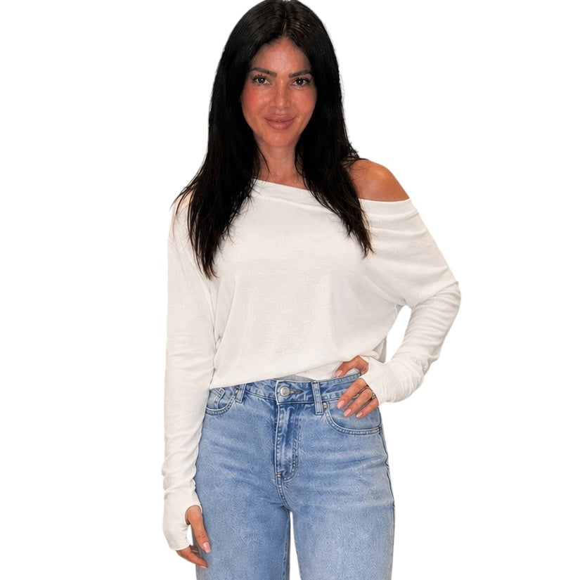 Woman wearing a white off-shoulder top and blue jeans on a white background