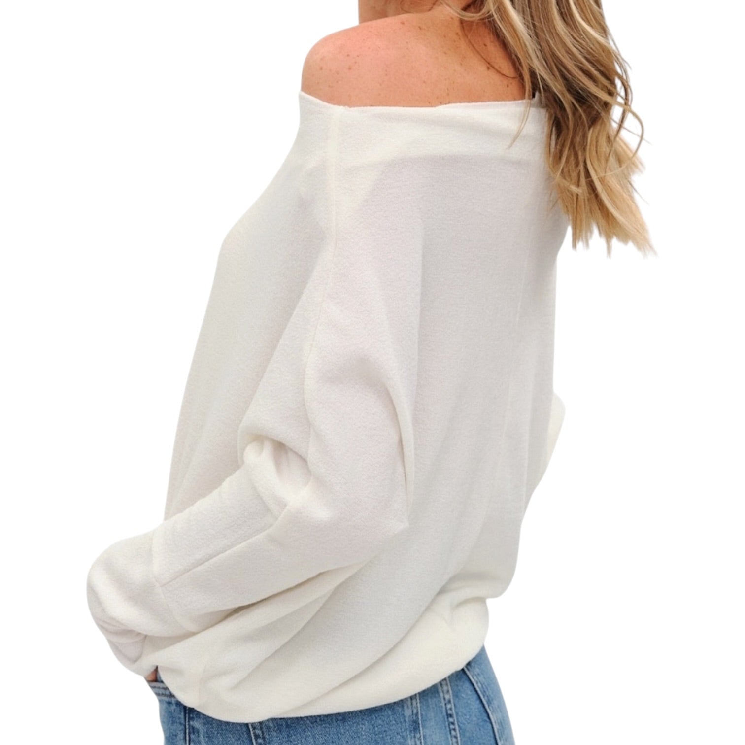 White off-shoulder sweater worn by a person on a white background