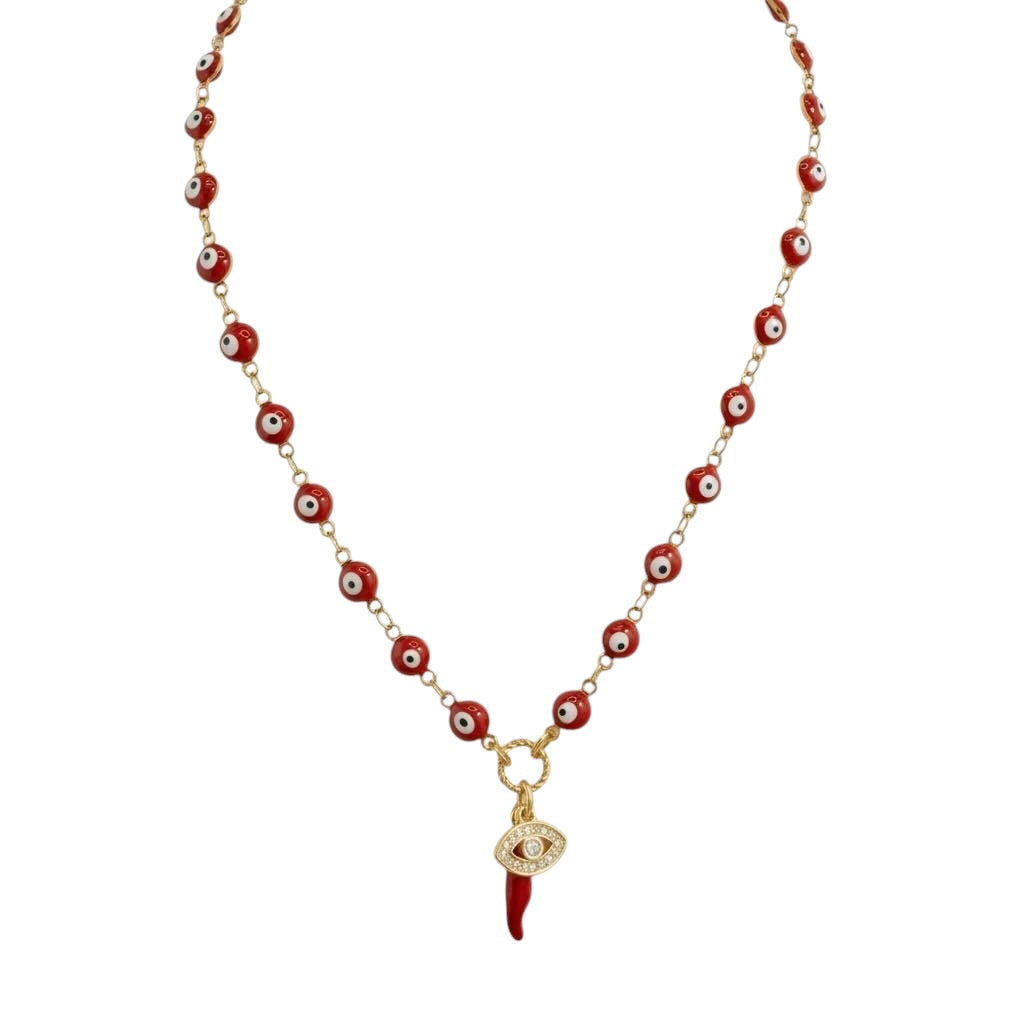 Necklace with red beads and a red dagger charm on a white background