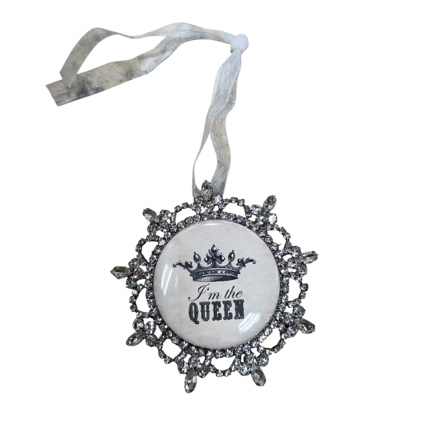 A silver-toned ornate Christmas ornament with a white circular center featuring a black crown graphic and the text 'I'm the QUEEN'. The ornament hangs from a white ribbon, shown against a plain white background.
