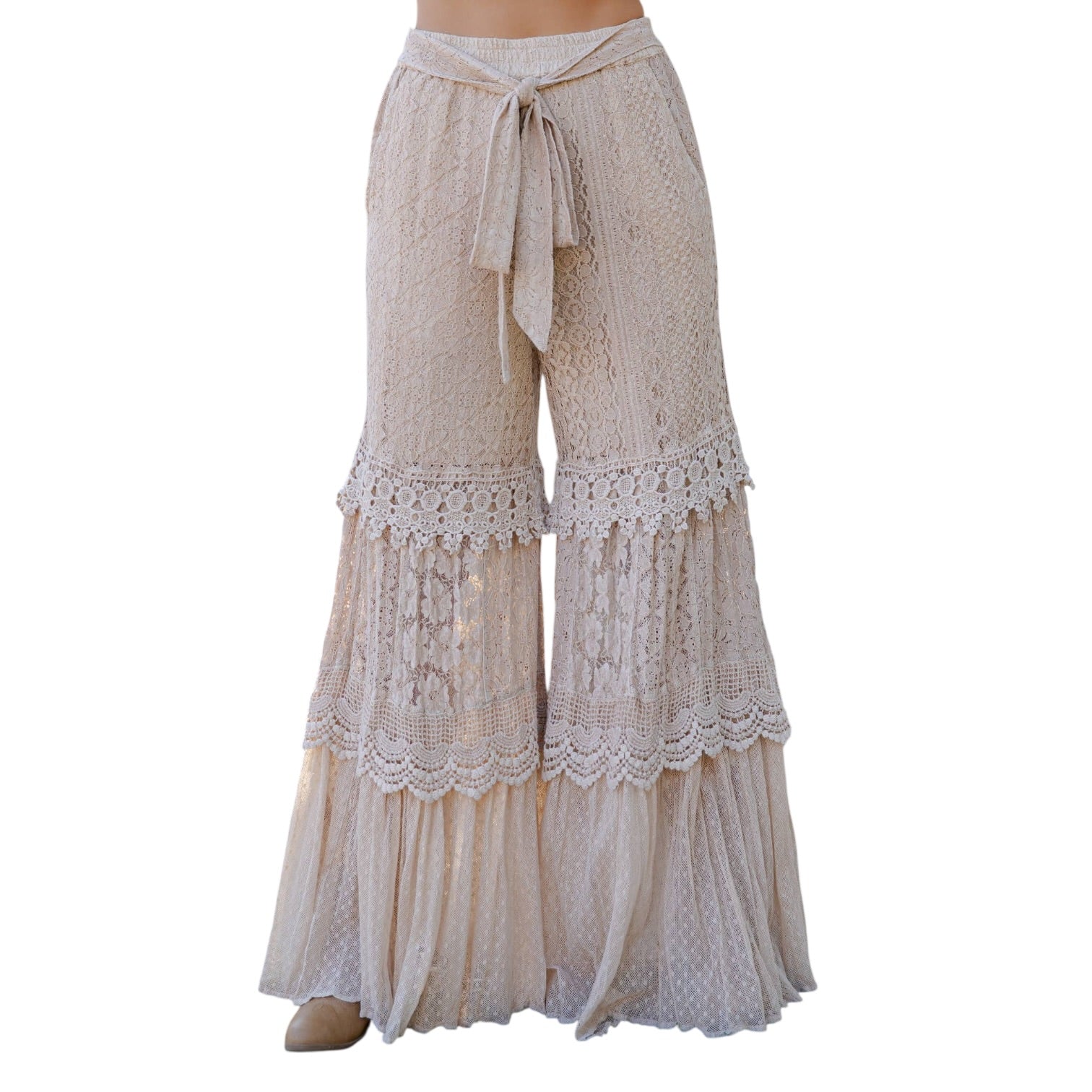 Beige lace pants with a tie waist on a white background