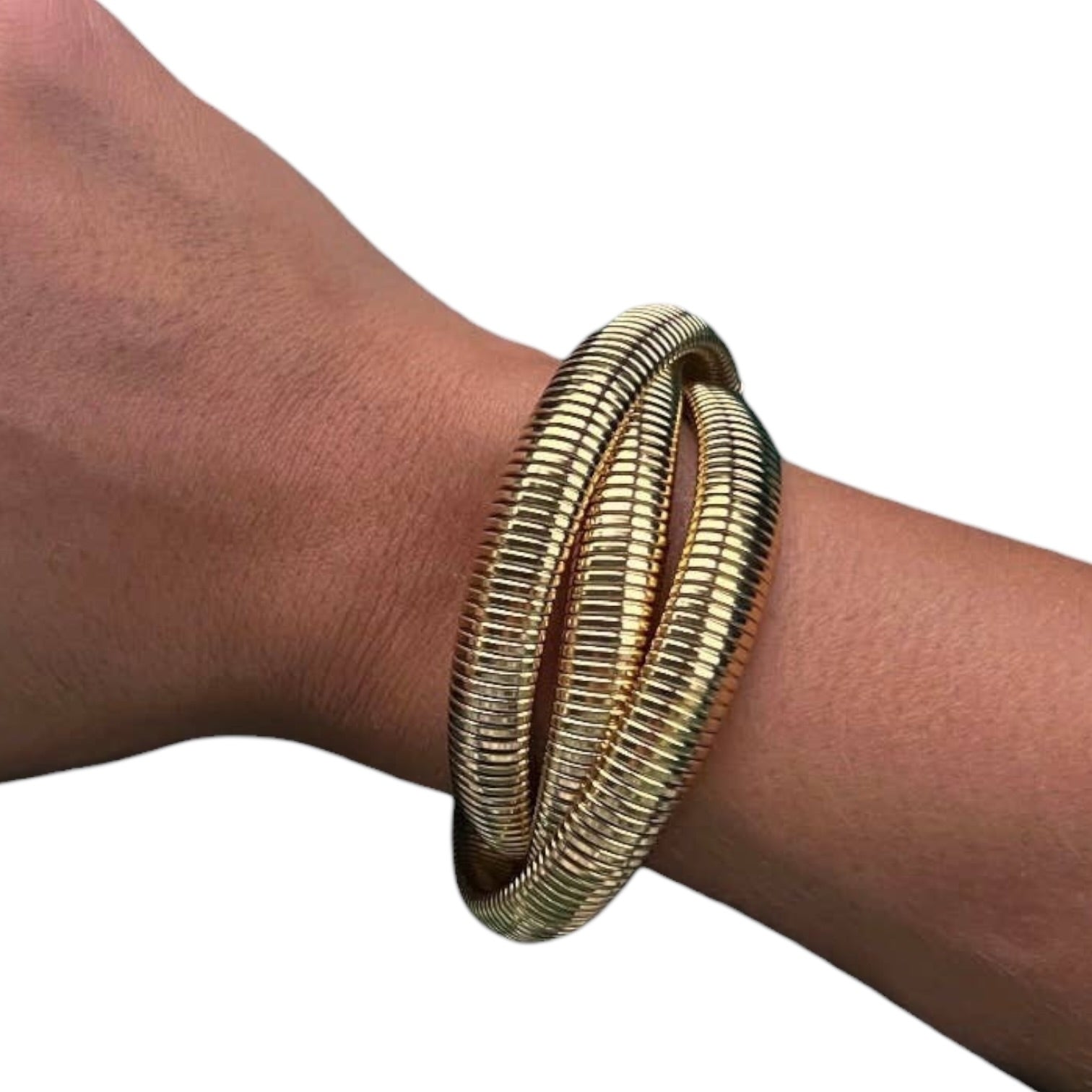 Gold bangles on a wrist against a white background