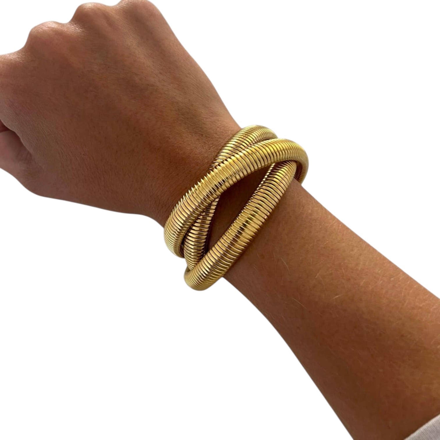 Gold bracelet on a wrist against a white background