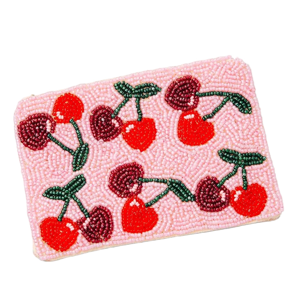 Pink clutch with cherry design on a white background
