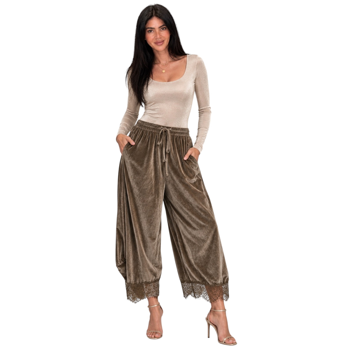A woman modeling a two-piece outfit featuring high-waisted, wide-leg brown velvet pants with lace trim and a matching beige long-sleeve scoop-neck top, set against a plain white background.