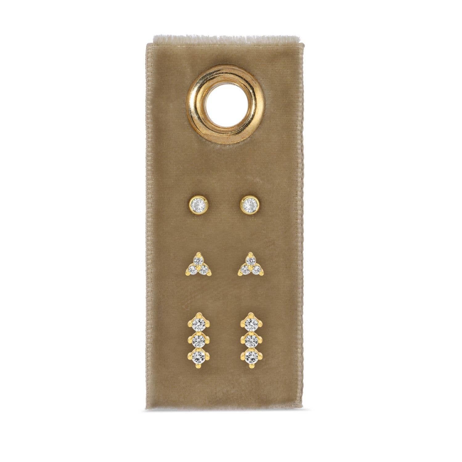 Set of gold and silver earrings on a beige card with a gold ring design.