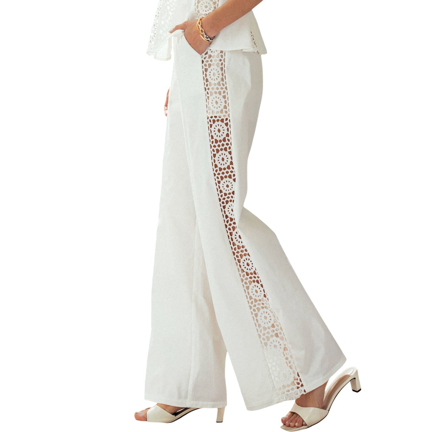 White pants with lace trim worn by a person on a white background
