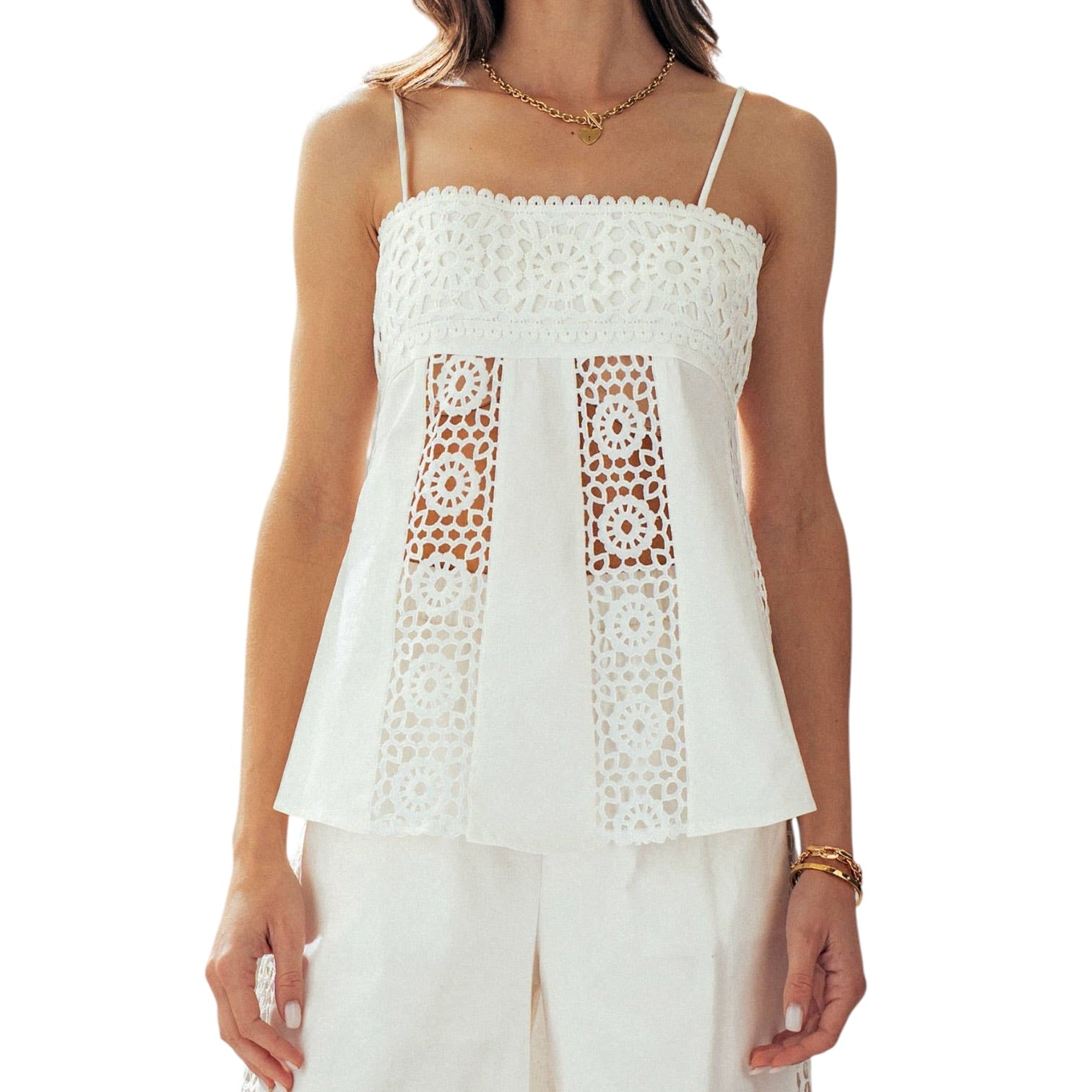White lace top worn by a person on a white background
