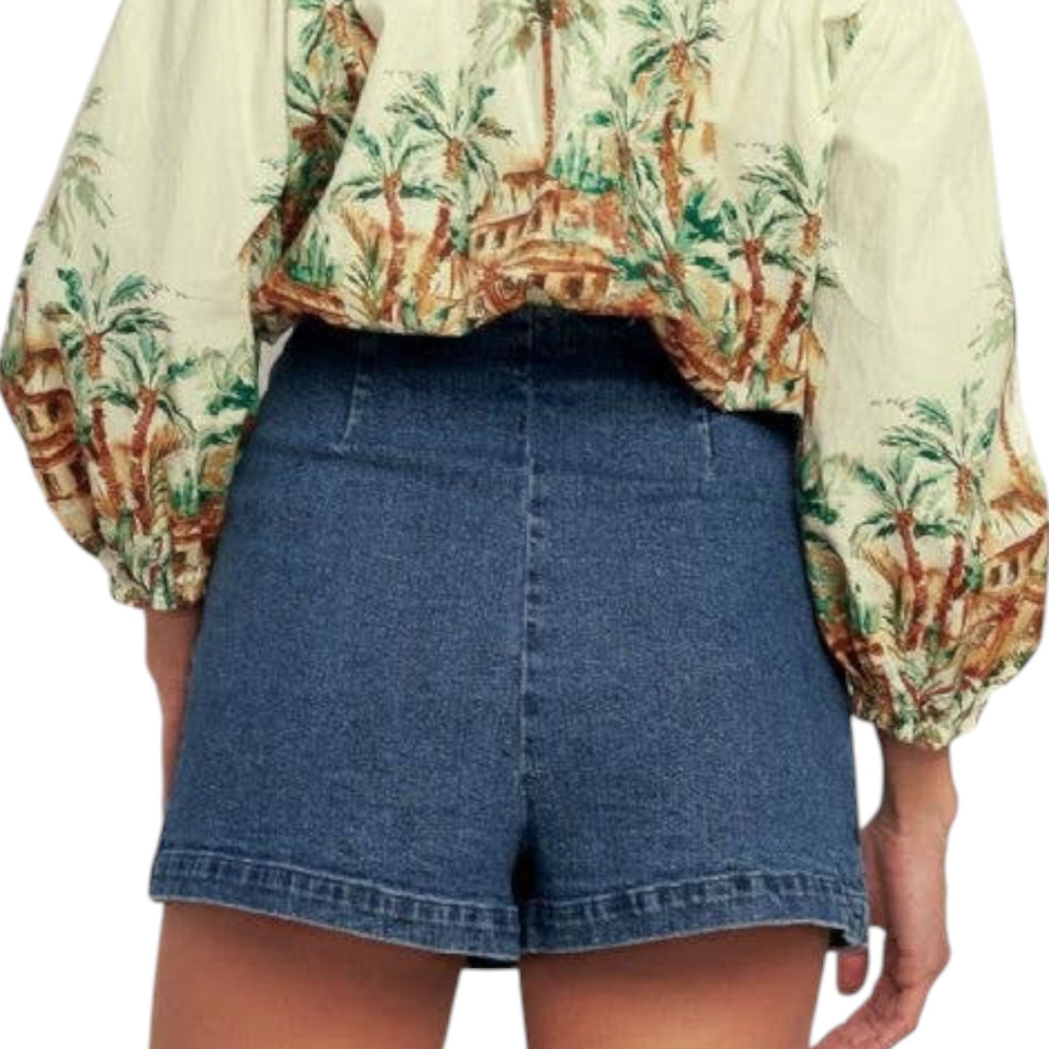 woman wearing denim skort with gold buttons on white background