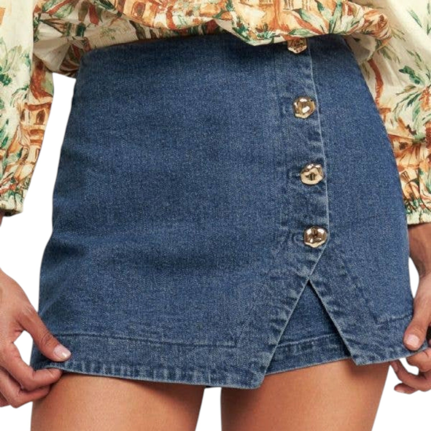 woman wearing denim skort with gold buttons on white background
