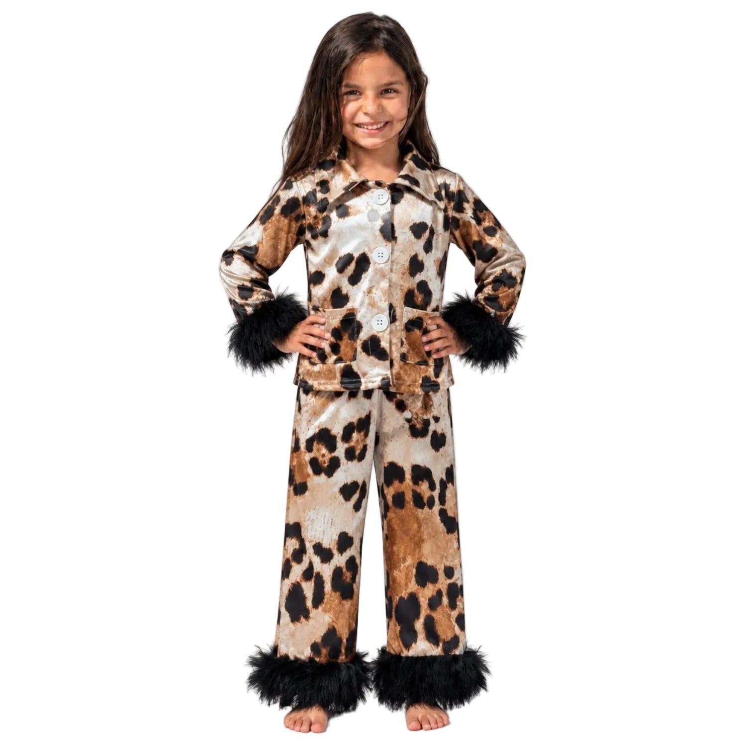 A young girl modeling a leopard print pajama set with black faux fur trim on the cuffs and hem, standing against a plain white studio background.