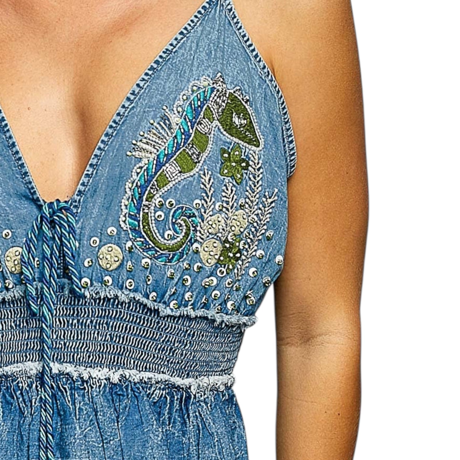 Denim dress with intricate embroidery on a white background