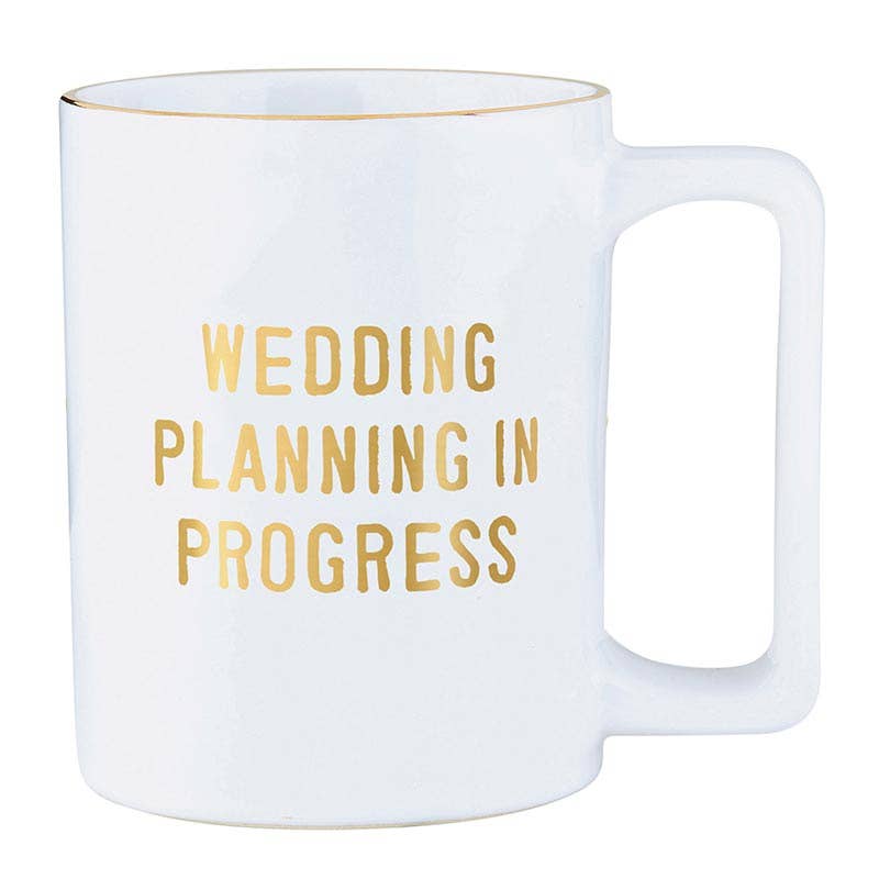 White mug with gold text 'Wedding Planning In Progress' on a white background