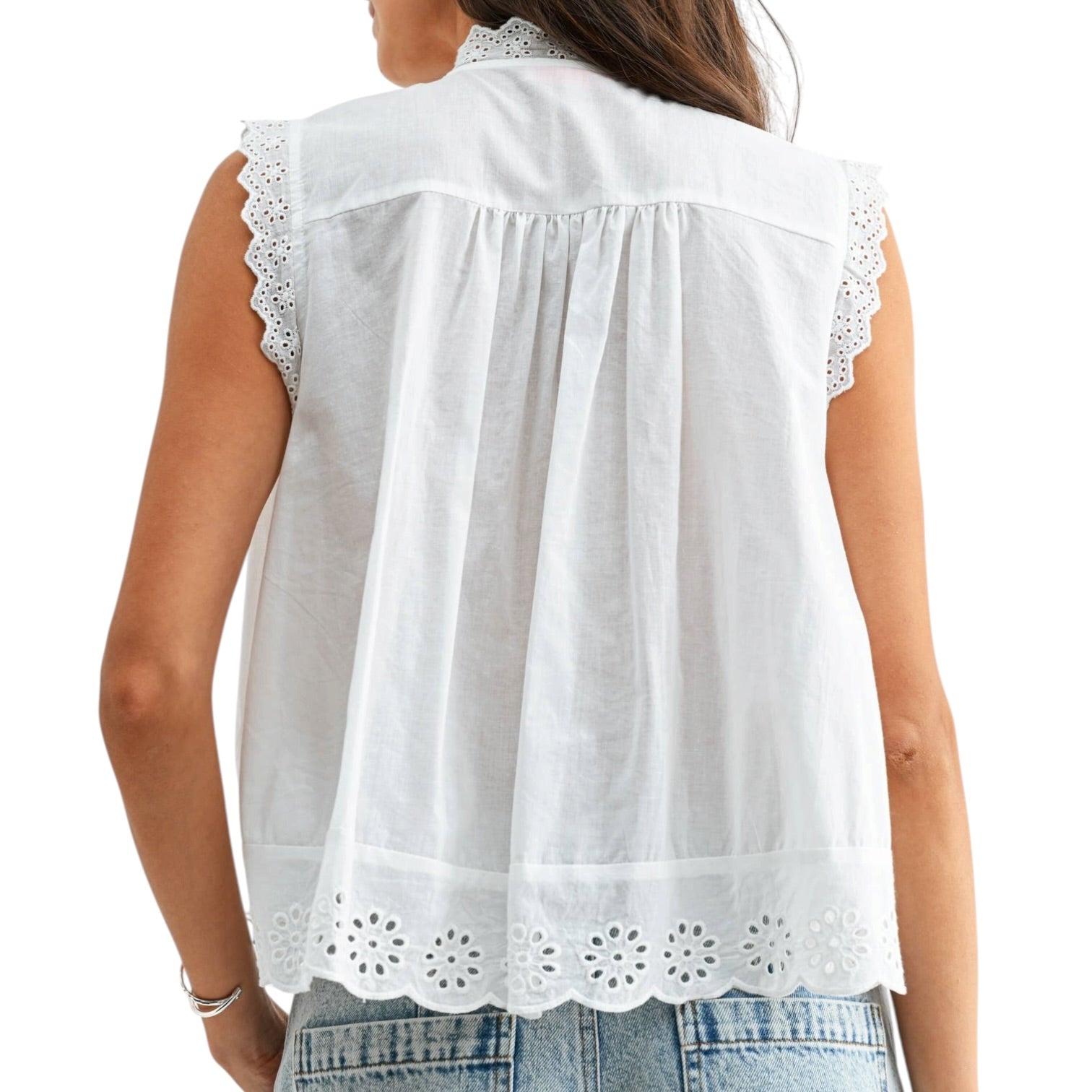 a woman wearing a white eyelet button down tank top on white background