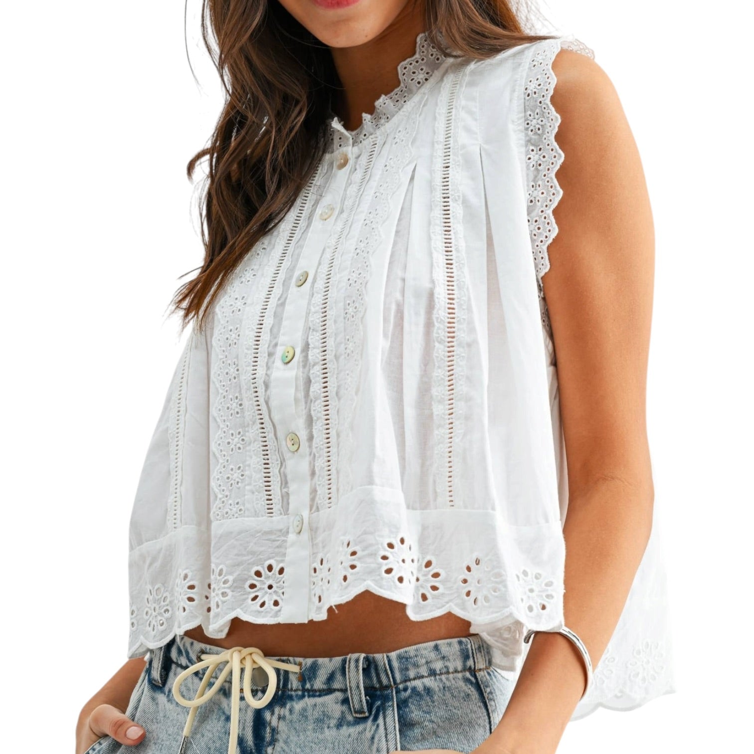 a woman wearing a white eyelet button down tank top on white background
