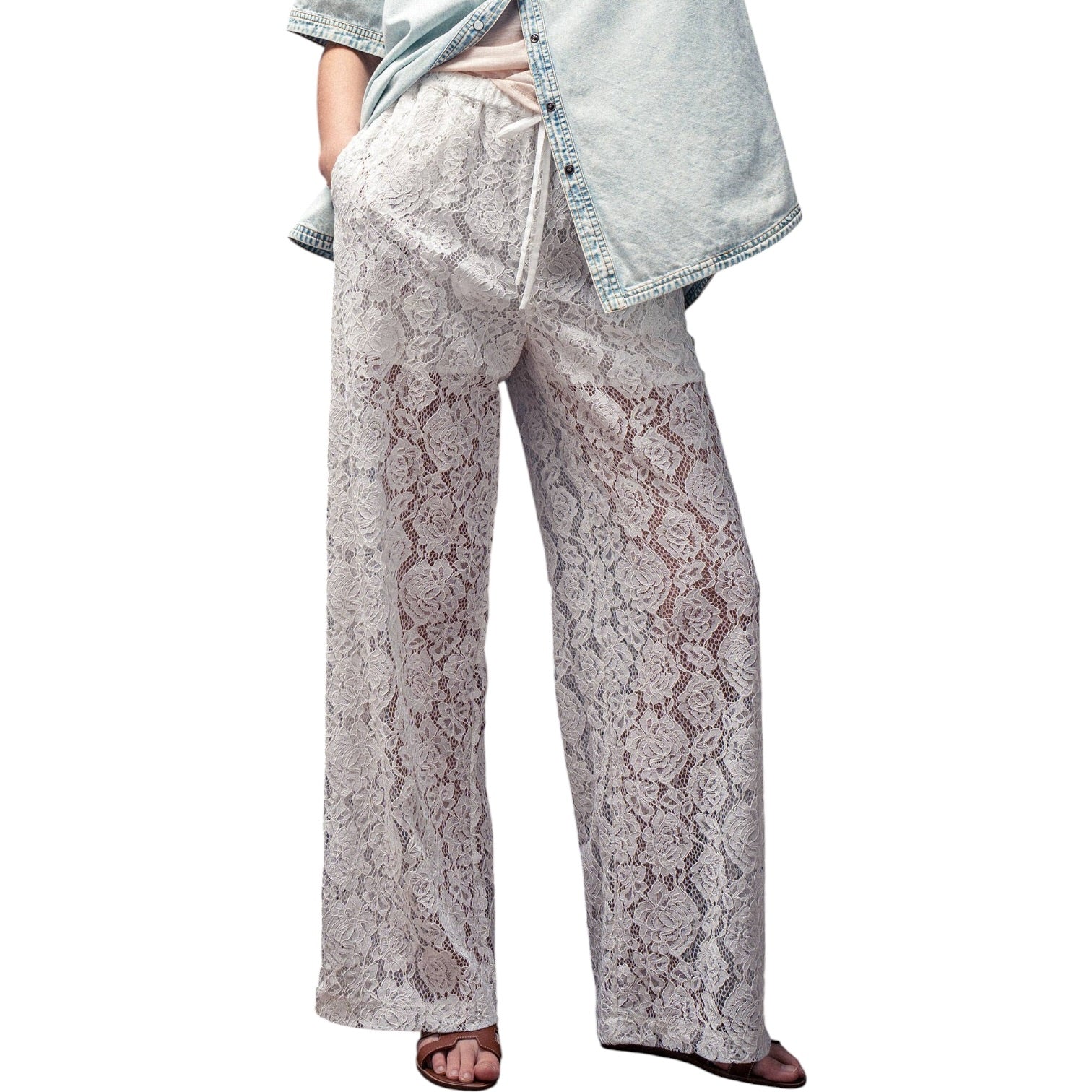 Lace pajama pants worn by a person on a white background