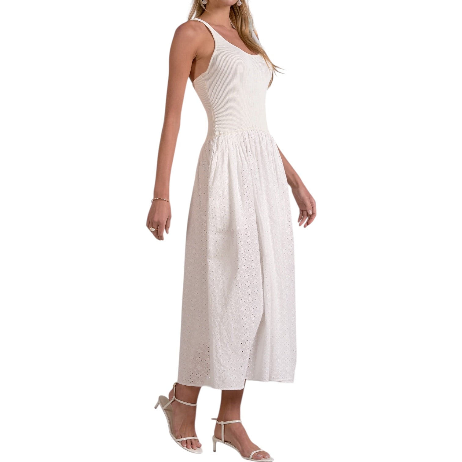 Woman wearing a white sleeveless dress on a white background