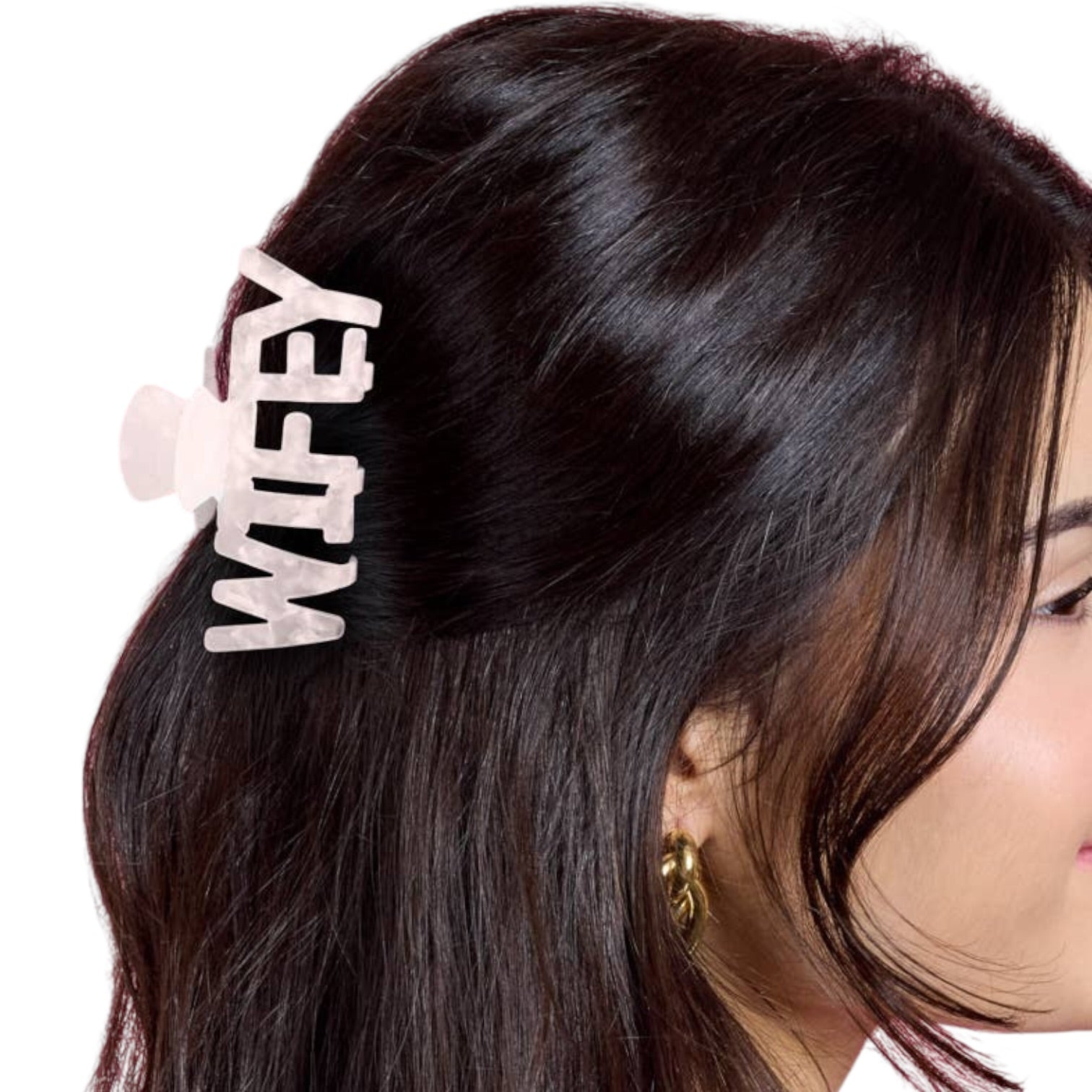 Hair clip with 'WIFEY' text on a person's hair against a white background