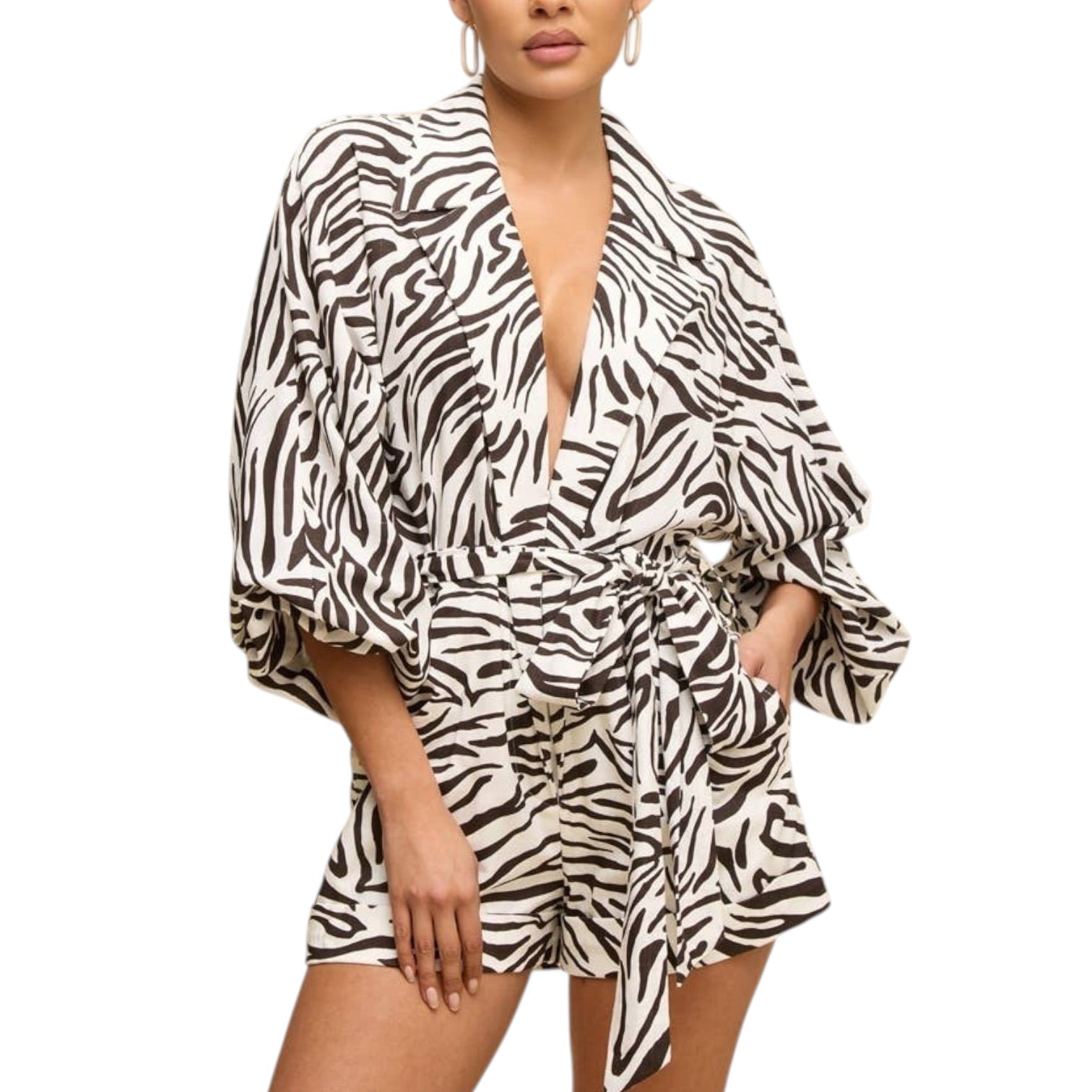 Woman wearing a zebra print romper on a white background