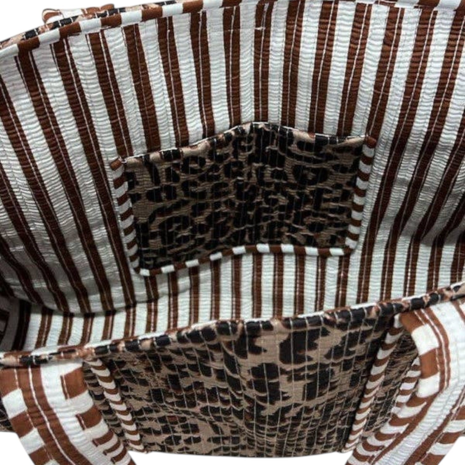 Close-up of a woven basket with brown and white striped pattern and leopard print pocket.