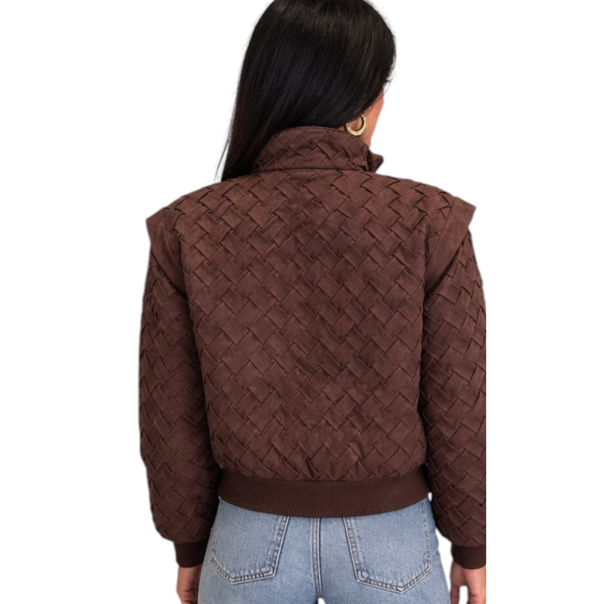 A woman viewed from the back wearing a dark brown cropped jacket with a textured woven pattern, paired with light blue jeans, against a plain white background.