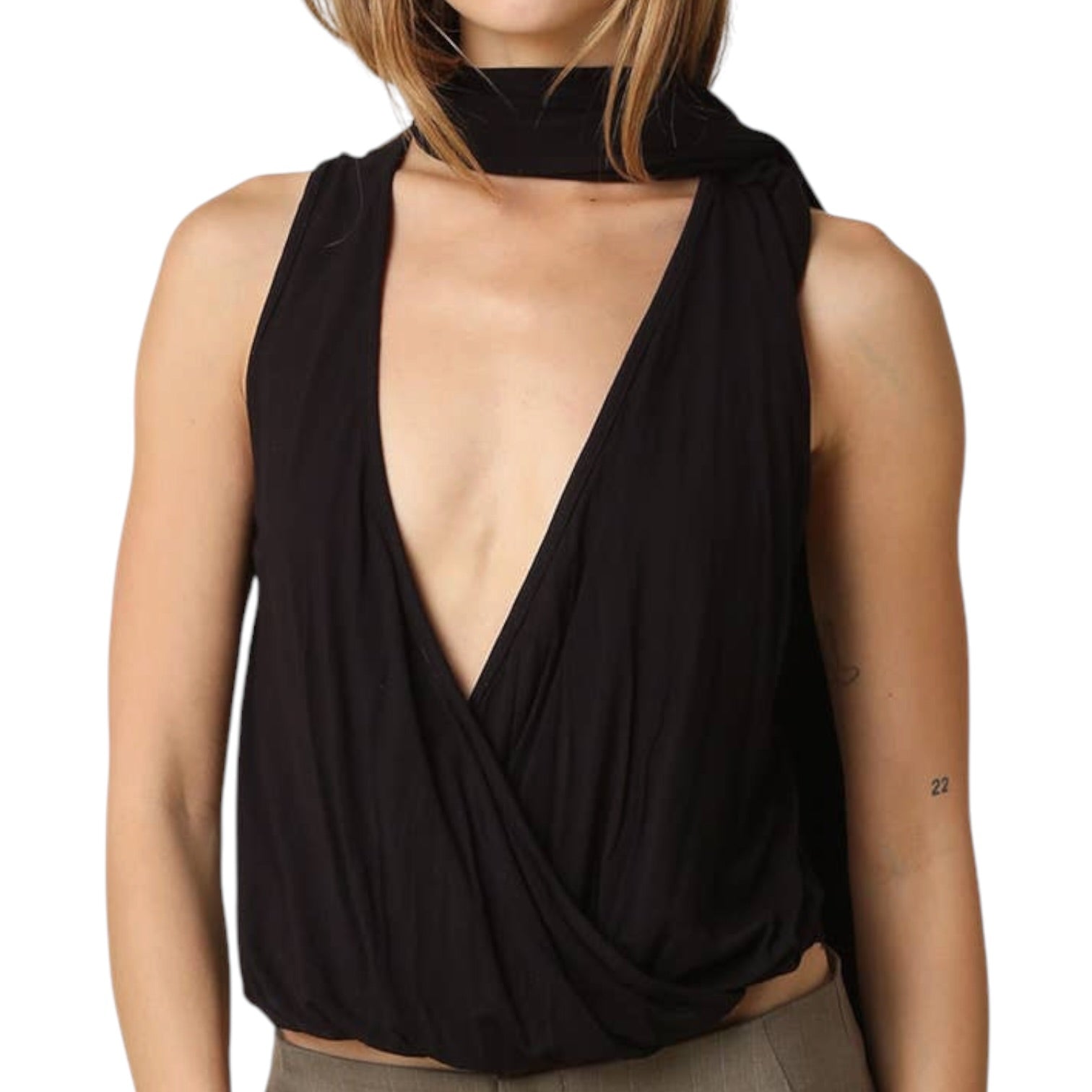 Black sleeveless top with deep neckline worn by a person on a white background