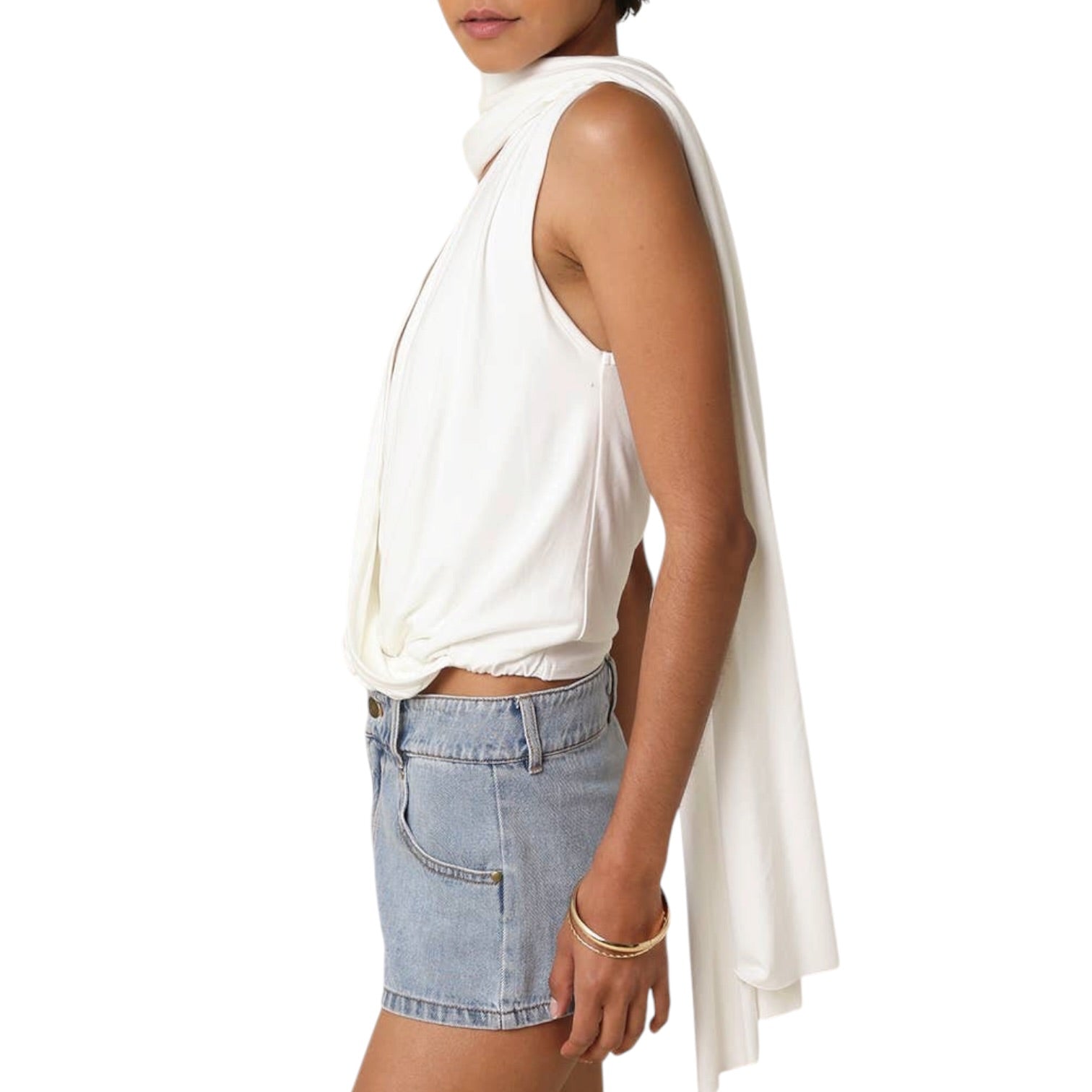 Person wearing a white sleeveless top and denim shorts on a white background