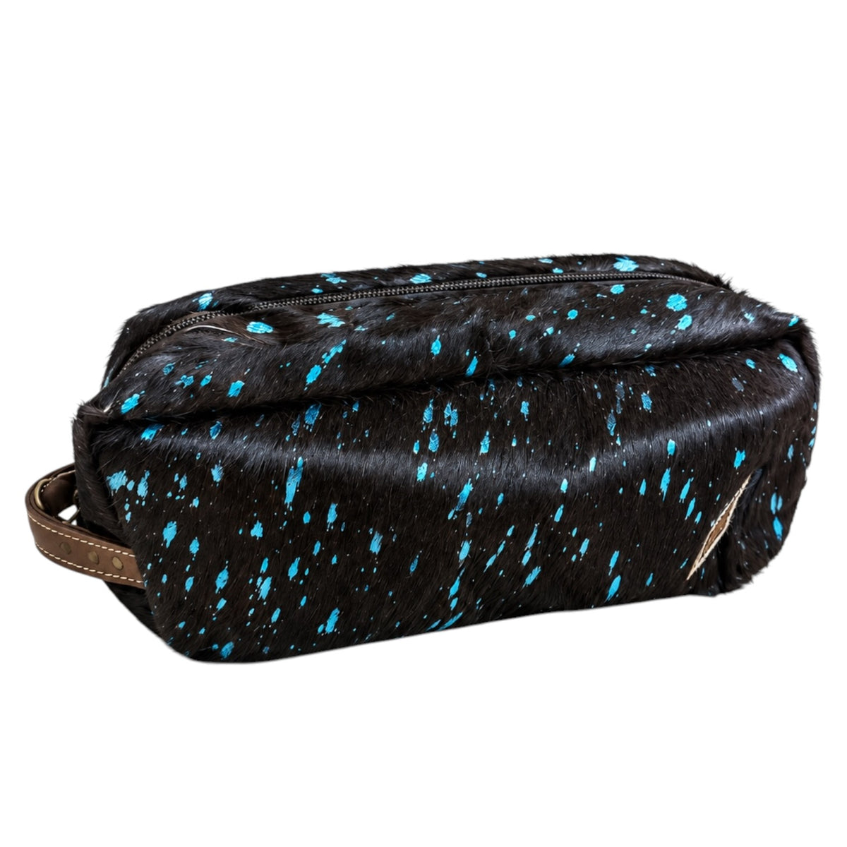 A black faux-hair zippered pouch with bright blue paint splatter details and a brown leather strap, shown on a plain white background.