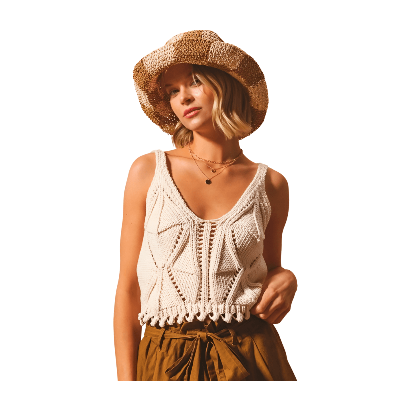 Handcrafted oatmeal knit tank top featuring deep V-neckline and fringed hem, styled with a straw hat.