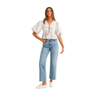 Model wearing pink Ditzy Floral Bow Crop Top with puff sleeves and high-waisted jeans, showcasing a casual and stylish look.