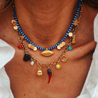 Multi charm summer necklace with blue beads, goldplated copper, and colorful charms, perfect for summer fashion.