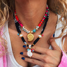 Handmade bohemian bandana and colorful beaded necklaces featuring ceramic shells and vibrant beads.