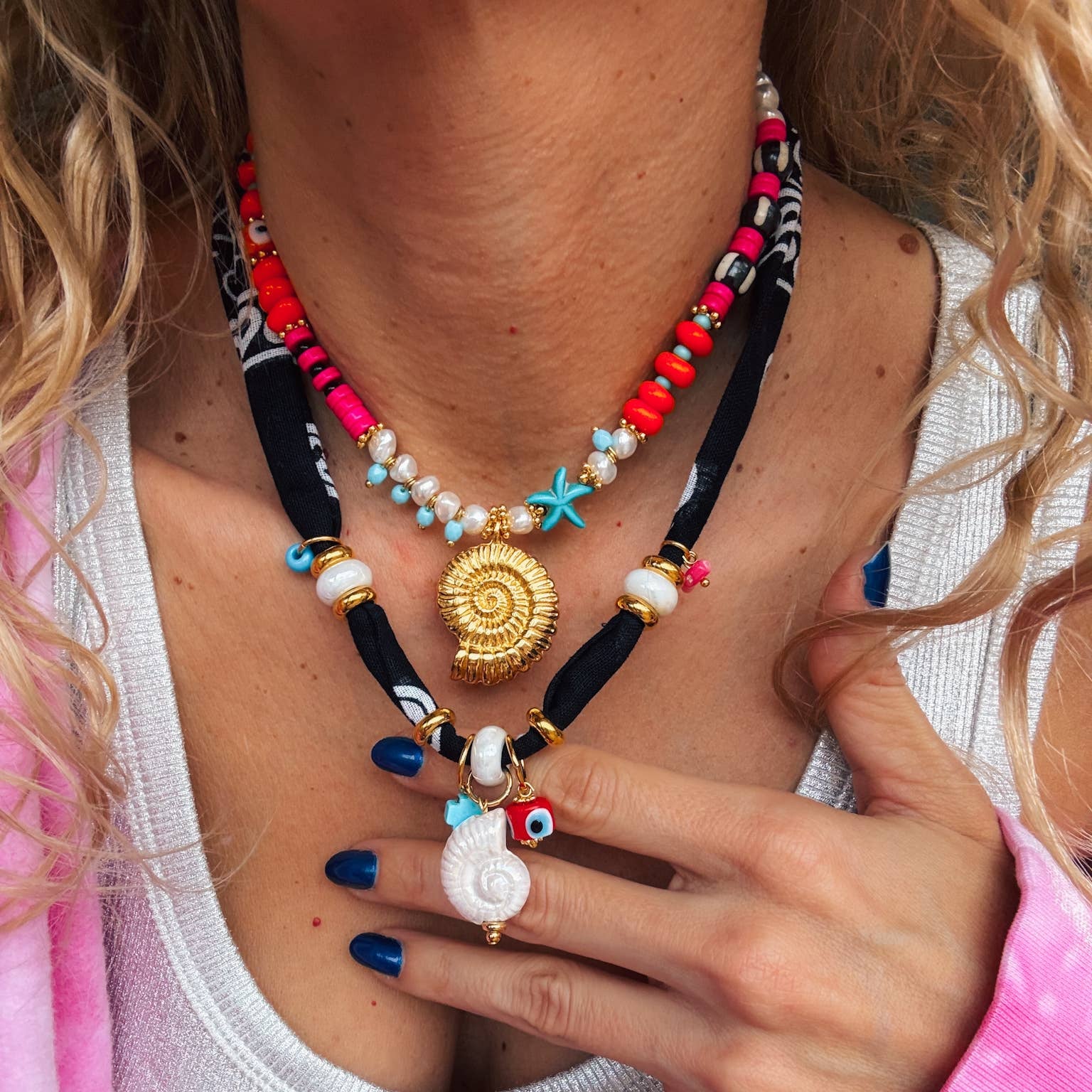 Handmade bohemian bandana and colorful beaded necklaces featuring ceramic shells and vibrant beads.