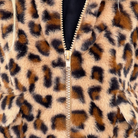 Close-up of a leopard print faux fur zip-up jacket with a gold zipper and a black inner lining.