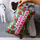 Main Character Needlepoint Pillow available at Alicia DiMichele Boutique – stylish women’s fashion and accessories.