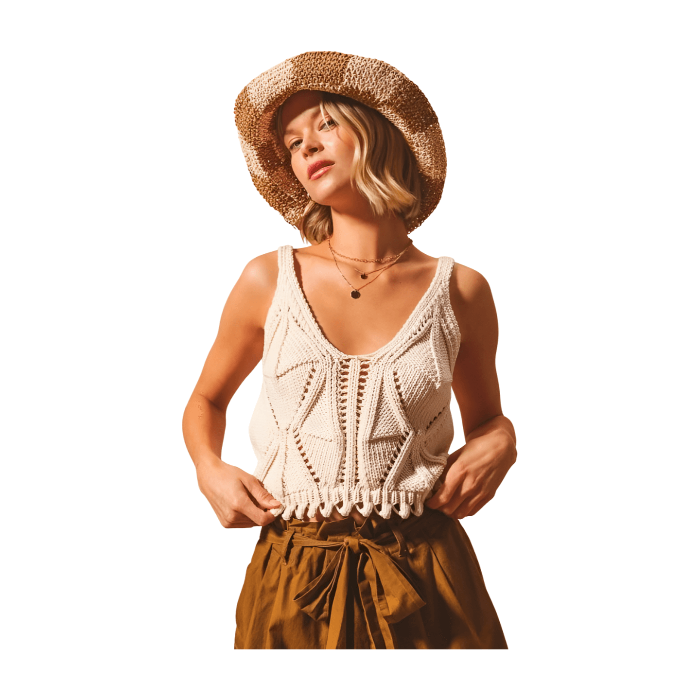 Artisan knit tank in oatmeal with deep V-neckline and fringed hem, styled with a straw hat.