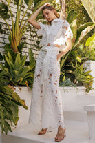 Floral lace belted pants set featuring a chic sheer blouse and flowing pants, perfect for elegant occasions.