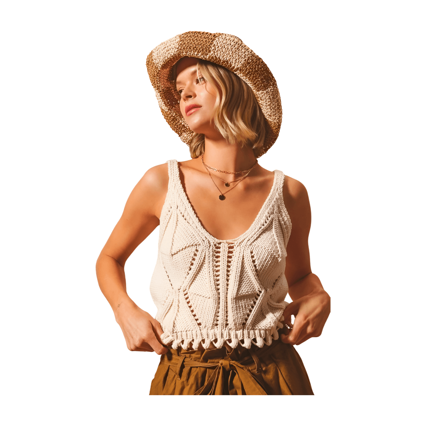 Artisan knit tank in oatmeal with deep V-neckline and fringed hem, paired with a woven hat and layered necklaces.