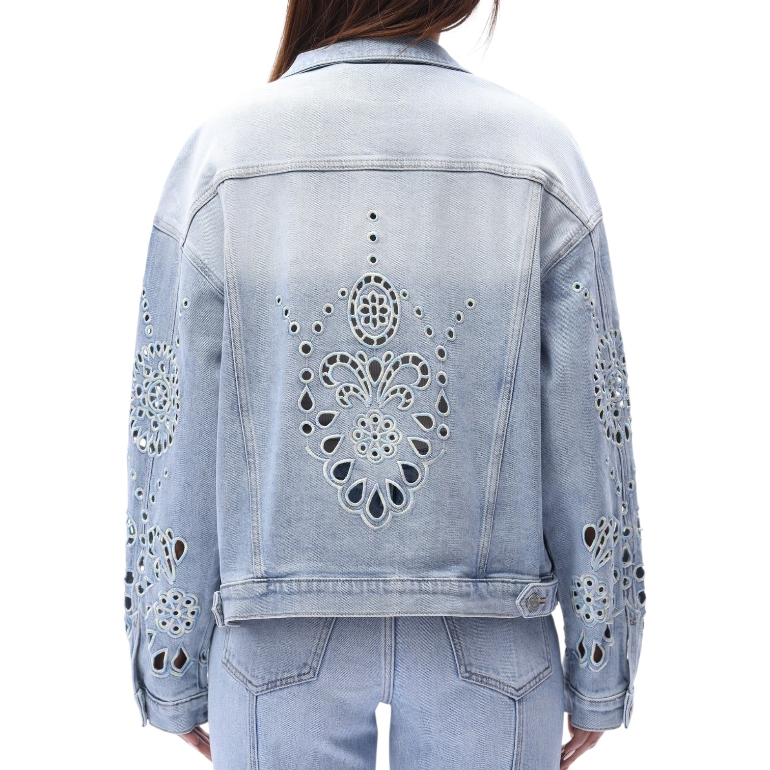 Light blue denim jacket with cut-out designs on a white background
