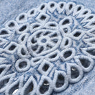 Close-up of intricate embroidery on denim fabric
