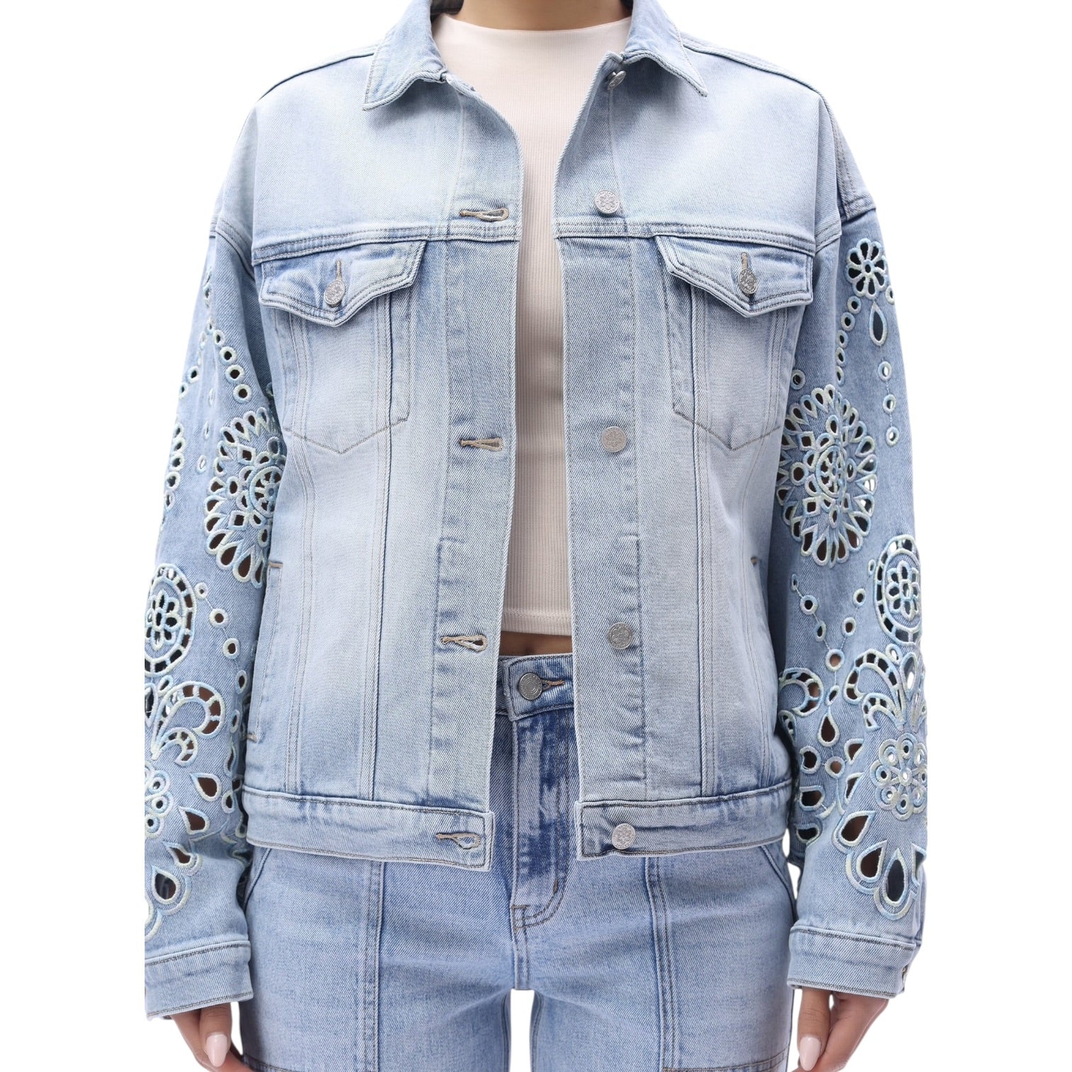 Light blue denim jacket with decorative cut-out patterns on a white background