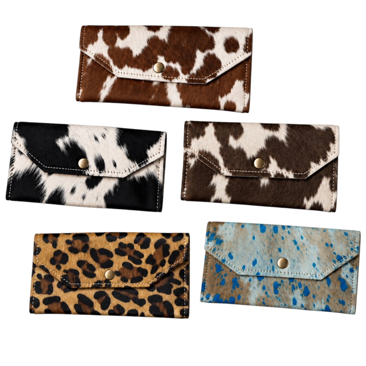 Five wallet-style clutch or bifold wallets with animal-print and speckled textures are arranged on a plain white background. The designs include brown and white cowhide, black and white cowhide, dark brown and white mottled, tan and black leopard, and tan and blue speckled.