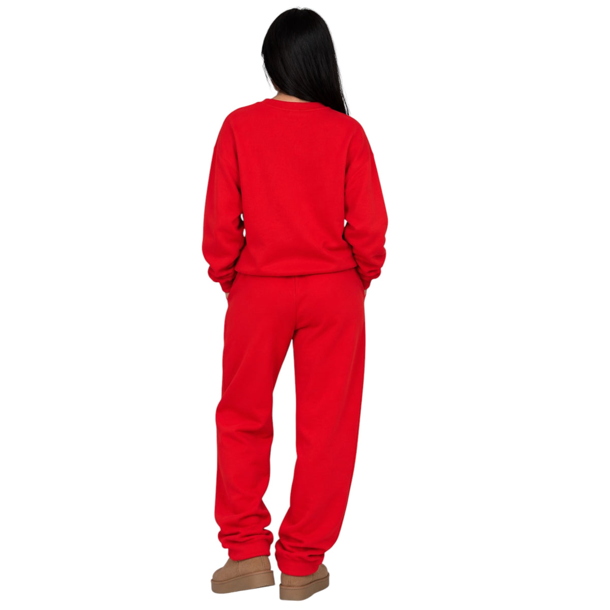 A person shown from the back wearing a bright red sweatshirt and matching red sweatpants, standing against a plain white background.