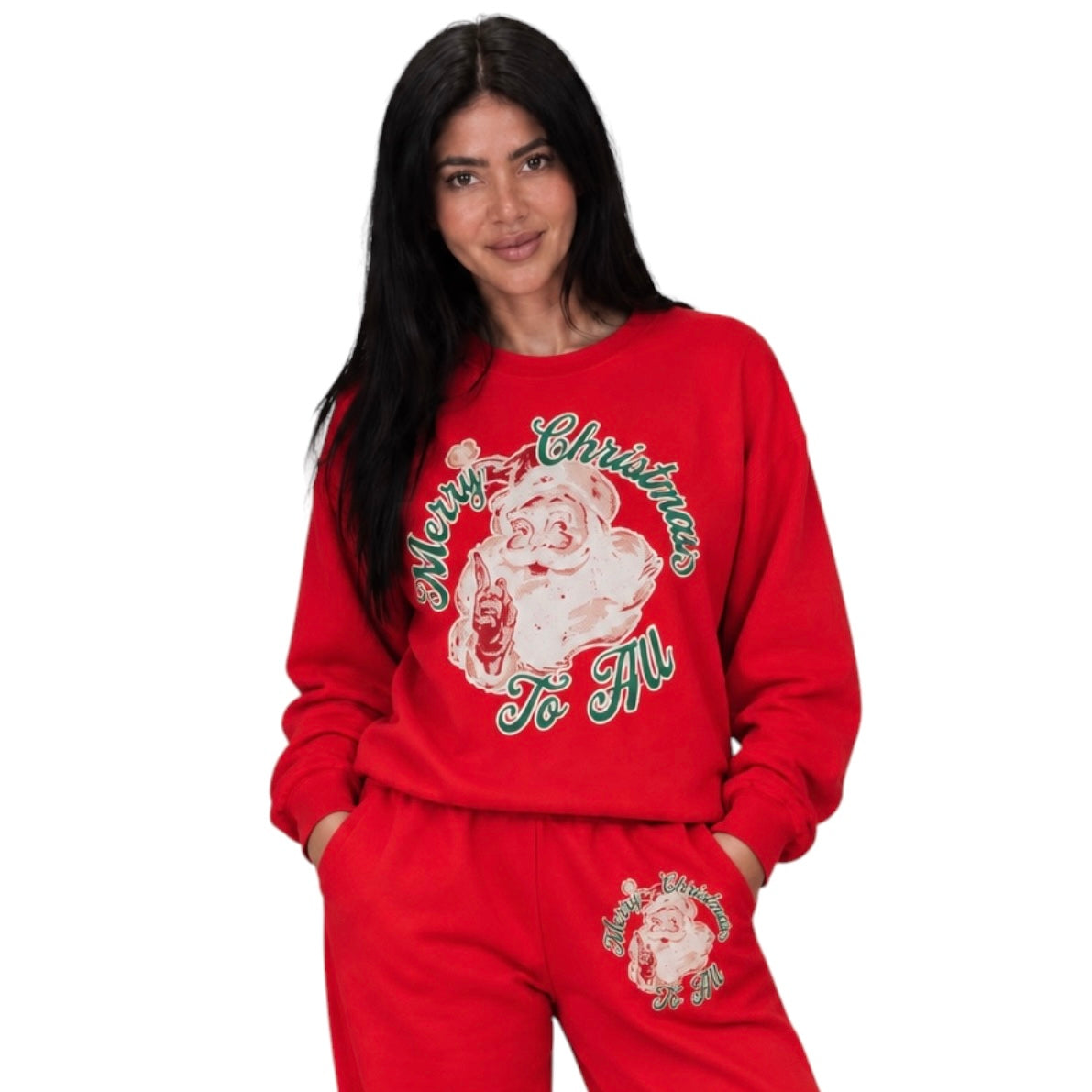 A woman modeling a red Christmas-themed sweatshirt and matching sweatpants set. The sweatshirt features a large graphic of Santa Claus with 'Merry Christmas To All' written in green script.